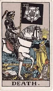 A skeleton in black armor rides a white horse carrying a black banner marked with a white rose, as a priest, a child, and a young woman look on.