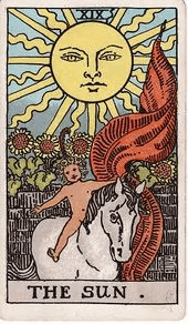 A naked child rides a white horse bareback beneath a huge, radiant sun with a face, sunflowers rising over a wall behind them.